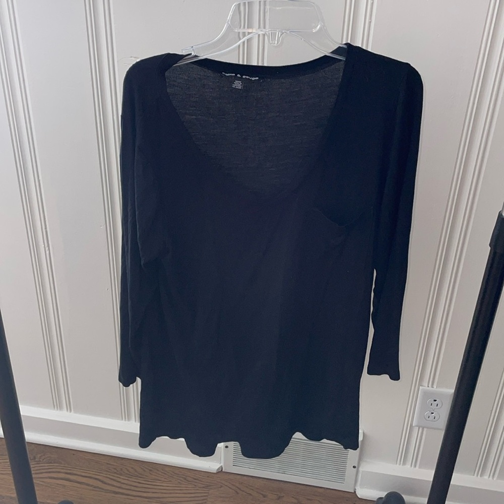 3/4 sleeve black T-shirt.